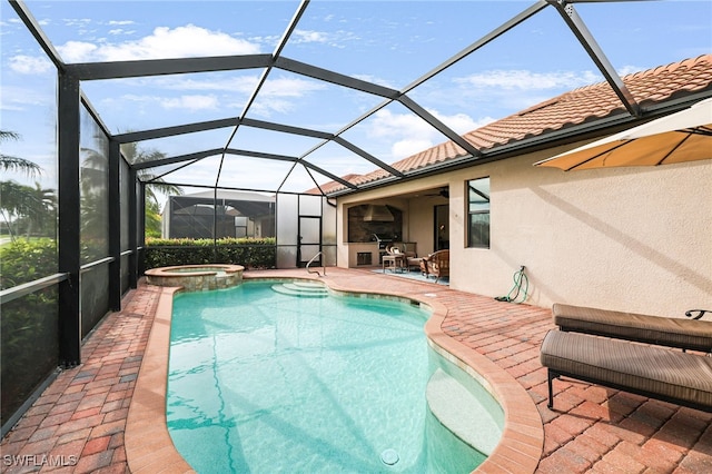 view of swimming pool featuring glass enclosure, a pool with connected hot tub, and a patio