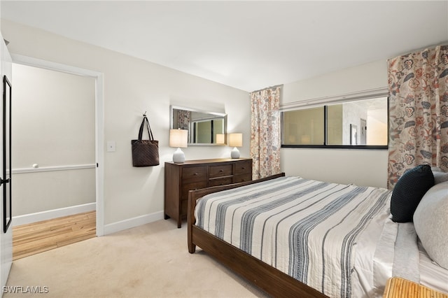 carpeted bedroom featuring baseboards