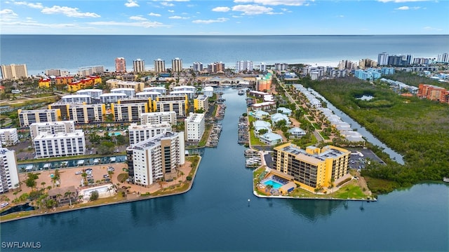 birds eye view of property featuring a water view and a view of city