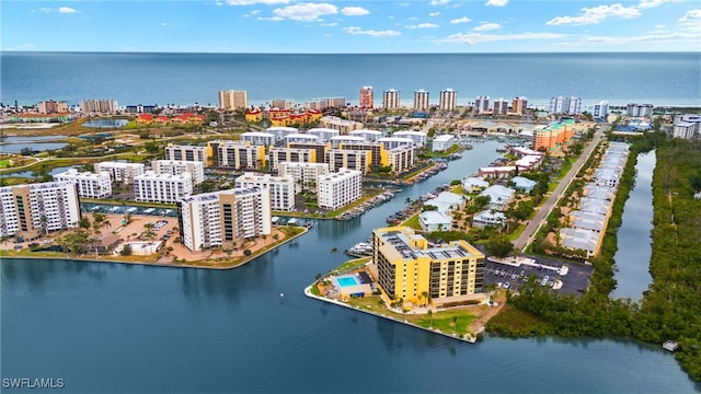 birds eye view of property with a view of city and a water view