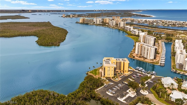 drone / aerial view featuring a water view and a view of city