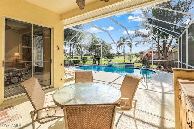 pool with ceiling fan, a patio, outdoor dining area, and a lanai