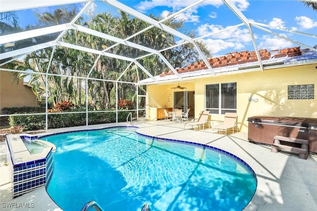 outdoor pool featuring glass enclosure, a patio area, and a hot tub