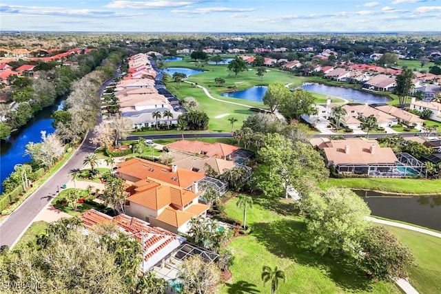 aerial view with a residential view, view of golf course, and a water view