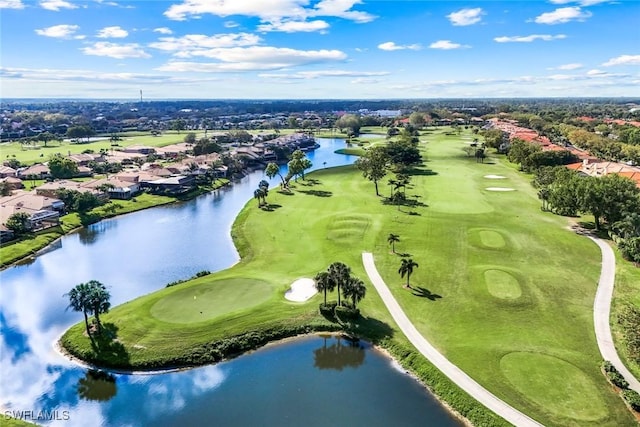 drone / aerial view with a water view and golf course view