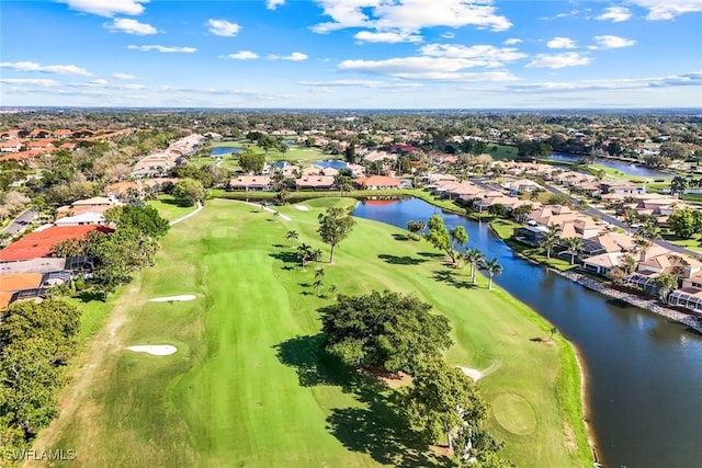 birds eye view of property with view of golf course, a water view, and a residential view