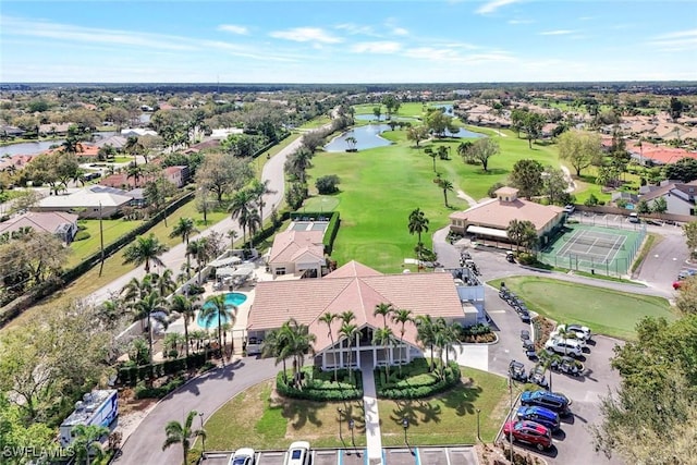 birds eye view of property with a water view and golf course view