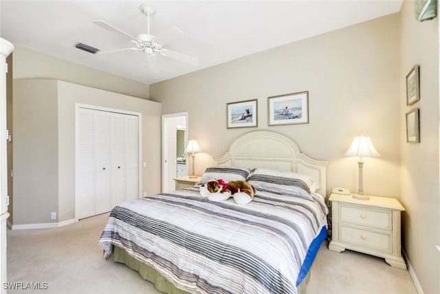 bedroom featuring a closet, visible vents, a ceiling fan, light carpet, and baseboards