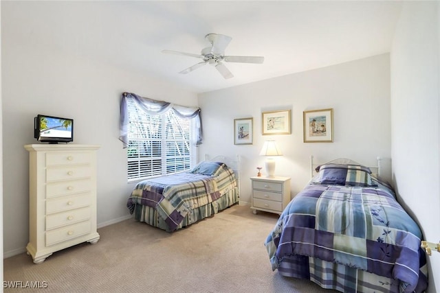 bedroom featuring a ceiling fan, light colored carpet, and baseboards