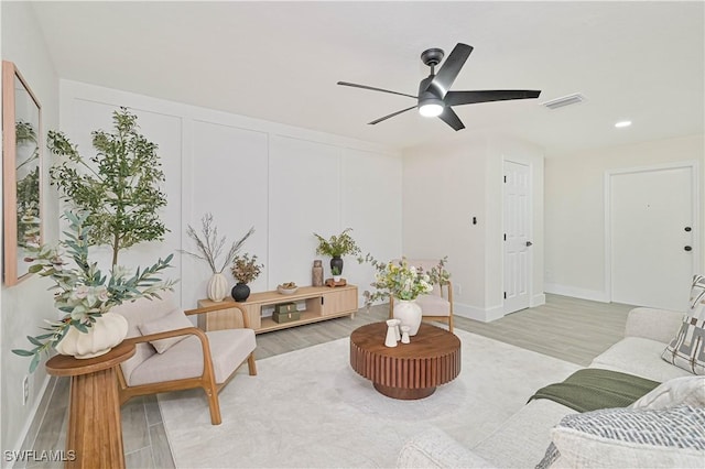 living area with visible vents, baseboards, light wood-style flooring, ceiling fan, and recessed lighting