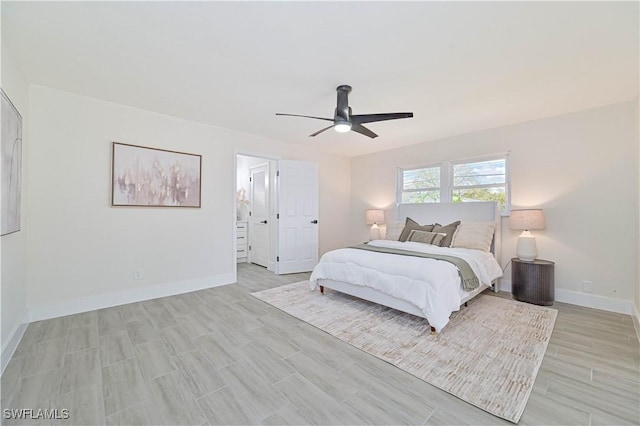 bedroom featuring ceiling fan, light wood-style flooring, and baseboards