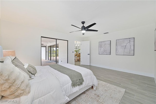 bedroom featuring ceiling fan, wood finished floors, and baseboards