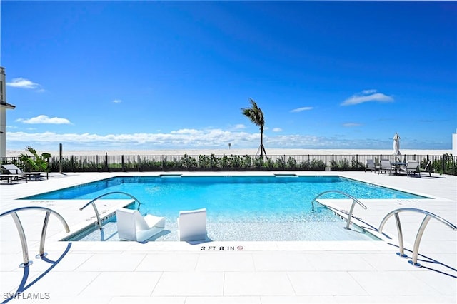 pool with fence and a patio