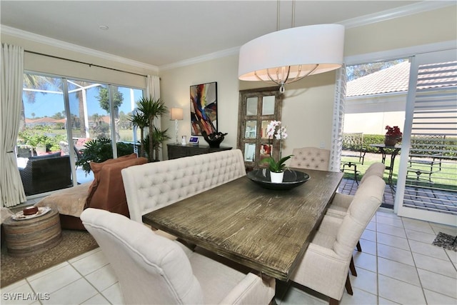 dining area featuring plenty of natural light, ornamental molding, and tile patterned floors