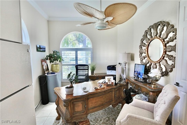 home office with a ceiling fan, crown molding, and light tile patterned flooring