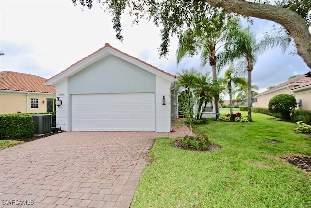 single story home featuring cooling unit, decorative driveway, a front lawn, and stucco siding