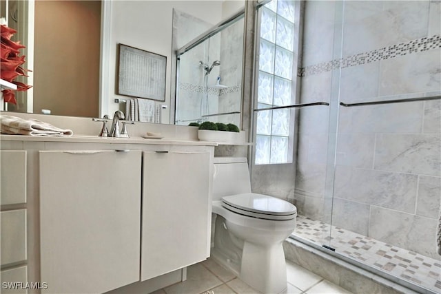 full bathroom with vanity, a stall shower, tile patterned flooring, and toilet