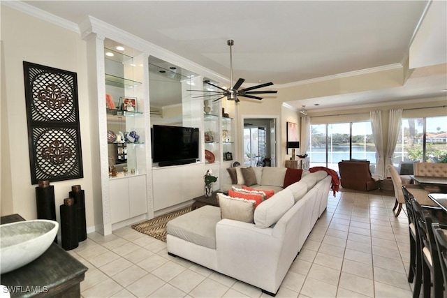 living room with light tile patterned floors, a ceiling fan, and crown molding