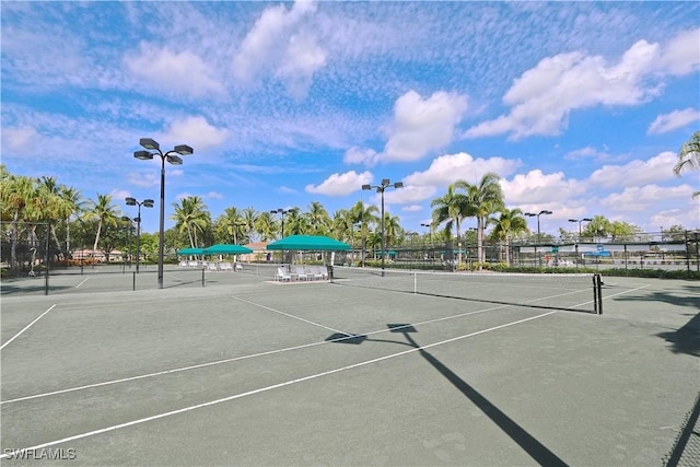 view of tennis court featuring fence