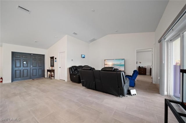 living area with vaulted ceiling and visible vents