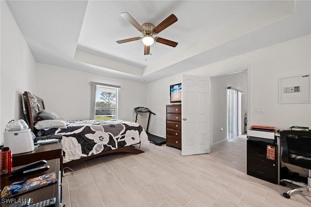 bedroom with a raised ceiling and ceiling fan