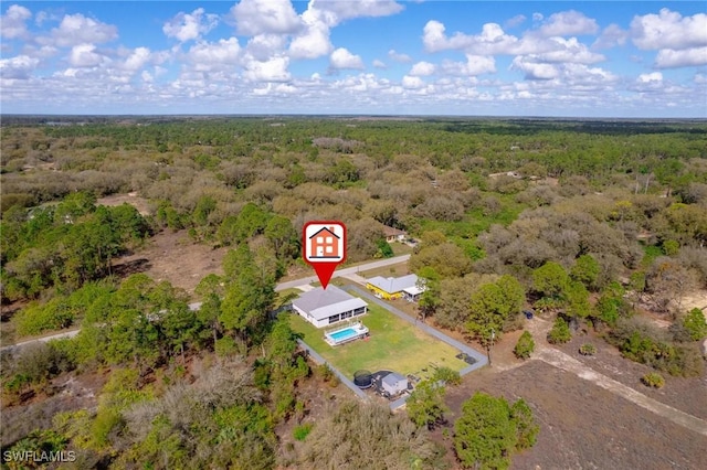 birds eye view of property with a forest view