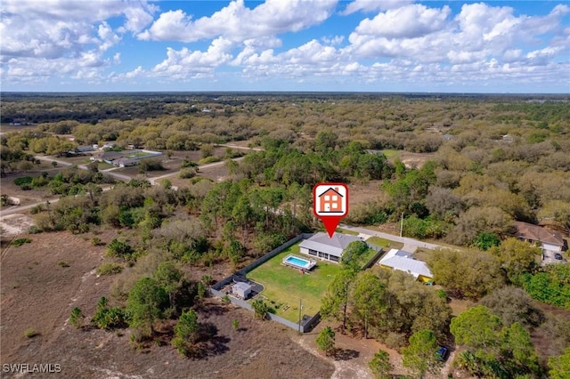 bird's eye view with a wooded view