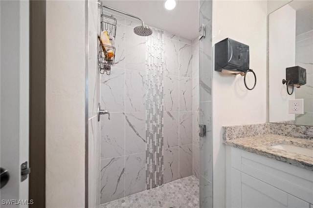 full bath with a stall shower and vanity