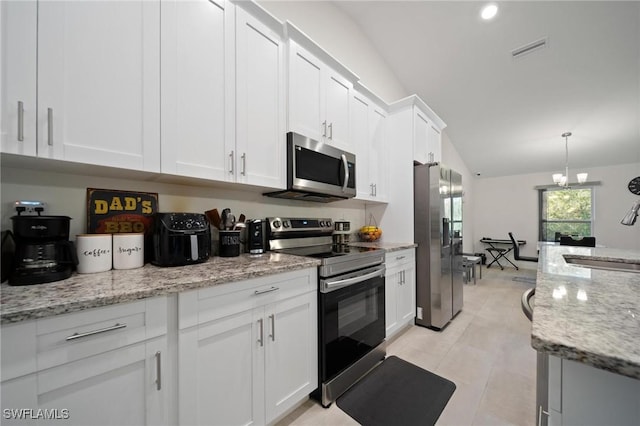 kitchen with light stone counters, visible vents, appliances with stainless steel finishes, white cabinets, and a sink