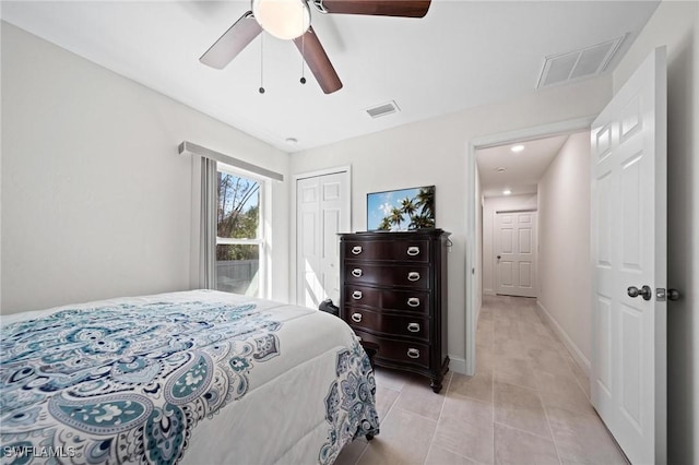 bedroom featuring light tile patterned floors, a closet, visible vents, and baseboards