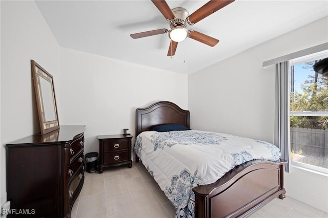 bedroom with ceiling fan and light tile patterned floors