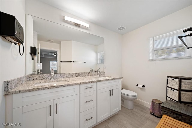 full bath featuring visible vents, a sink, toilet, and double vanity