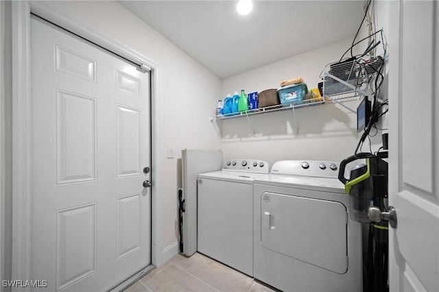 laundry area with laundry area, independent washer and dryer, and light tile patterned flooring