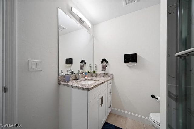 bathroom with toilet, vanity, visible vents, baseboards, and tile patterned floors