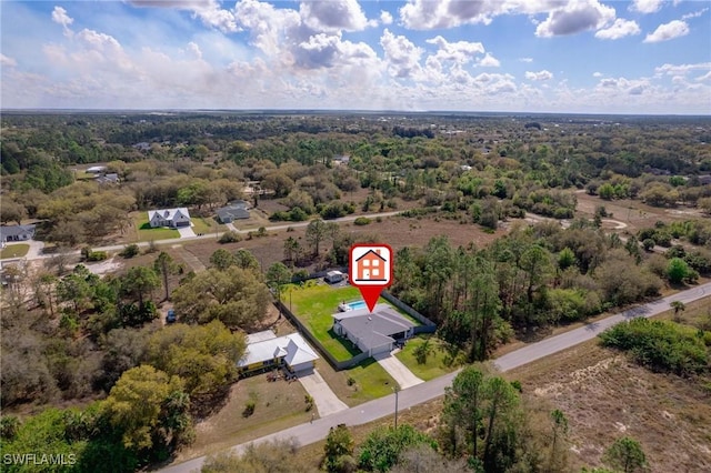 drone / aerial view featuring a view of trees