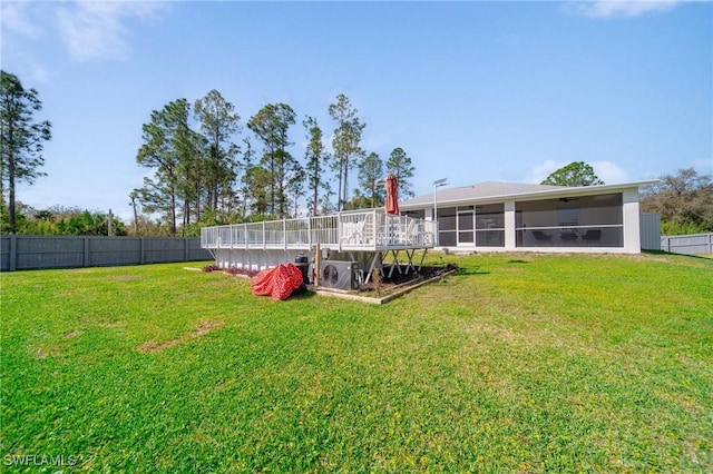 view of yard featuring a fenced backyard and a sunroom