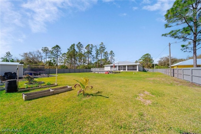 view of yard featuring a garden and a fenced backyard