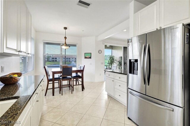 kitchen featuring decorative light fixtures, visible vents, white cabinets, light tile patterned flooring, and stainless steel fridge with ice dispenser