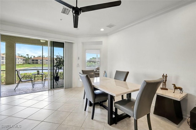 dining space with ornamental molding, a ceiling fan, visible vents, and light tile patterned floors