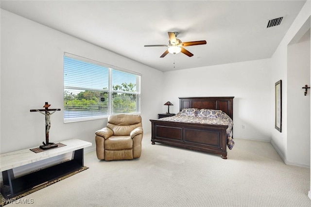 bedroom featuring visible vents, a ceiling fan, and light colored carpet