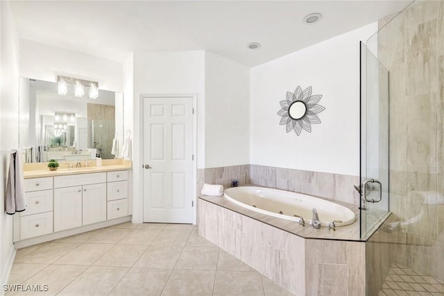 full bathroom with a stall shower, vanity, a whirlpool tub, and tile patterned floors