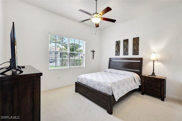 bedroom featuring baseboards, ceiling fan, and light colored carpet