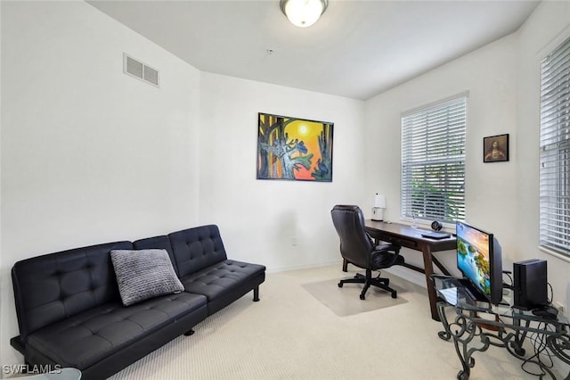 carpeted home office with visible vents and baseboards