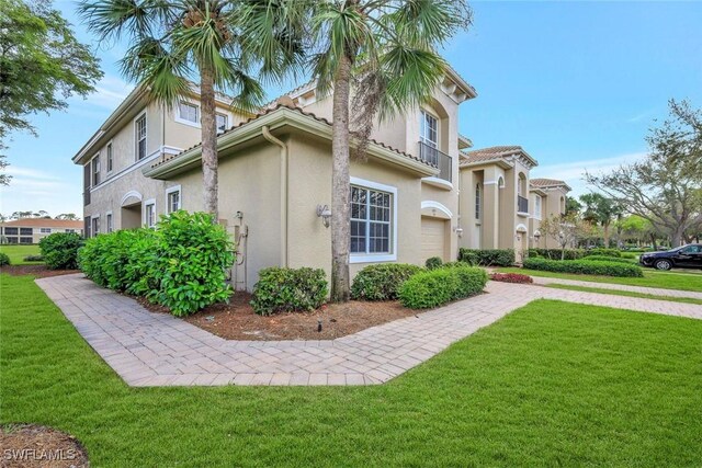 view of home's exterior featuring a lawn and stucco siding