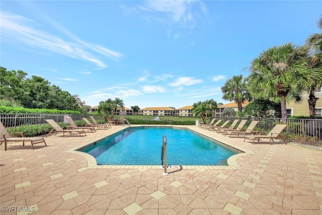 community pool featuring a patio and fence