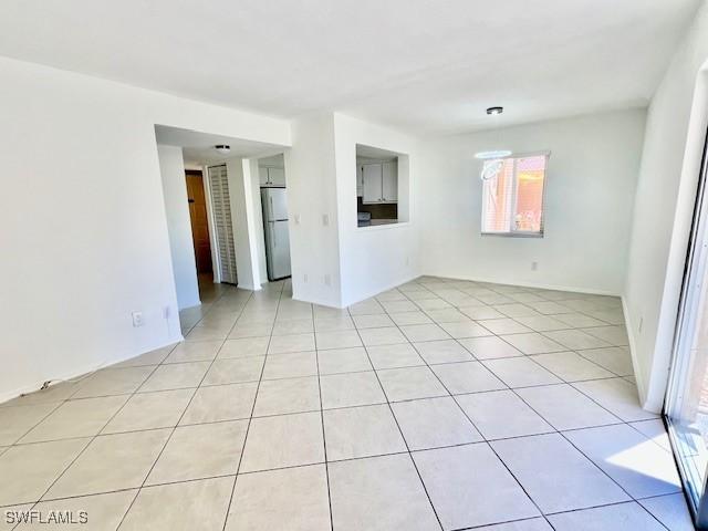 empty room with light tile patterned flooring