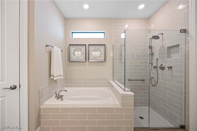 full bathroom featuring a stall shower and a garden tub