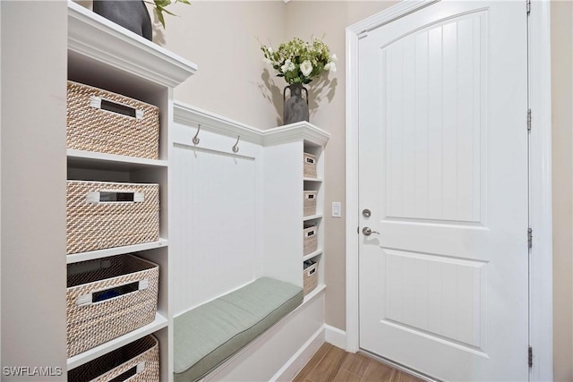 mudroom with baseboards and wood finished floors