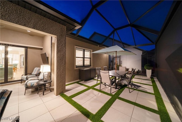 view of patio with glass enclosure and outdoor dining space