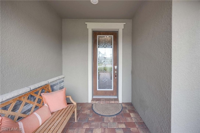 entrance to property with stucco siding